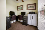 Home office setup with two computers and storage in Park Place Apartments, Louisville, Kentucky.