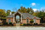 Entrance of Park Place Apartments with landscaping and parking, featuring community amenities in Louisville, Kentucky.