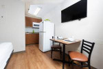 Cozy apartment with flat screen TV, kitchenette, and dining setup in Baton Rouge, LA