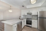 Renovated two-bedroom apartment kitchen with granite countertops and modern appliances at Park at Murano.