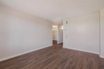 Spacious living area in a New Orleans apartment with modern design and wooden flooring.