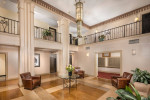 Elegant lobby of Miramar apartments in Washington, featuring parquet floors and cozy seating areas.