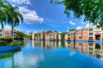 Beautiful view of the Park at Veneto Apartment Homes with a serene lake and lush landscaping in Fort Myers, FL.