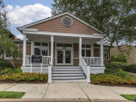 Front view of The Sycamores leasing office in Reston, VA, featuring welcoming steps and landscaped surroundings.