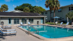 Luxury apartment community pool with lounge chairs at The Drake in St. Petersburg, FL.