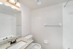 Modern bathroom in a fully renovated 1-bedroom apartment with granite countertops and stylish fixtures.