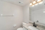 Modern bathroom with granite countertop and stylish fixtures in a renovated one-bedroom apartment at Park at Murano.