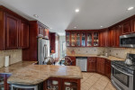 Charming kitchen in a Brooklyn home featuring granite countertops and stainless steel appliances.