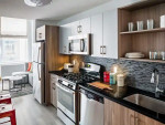 Modern kitchen in AVA DoBro apartment with stainless steel appliances and stylish cabinetry