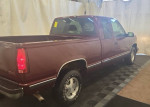 GMC 1500 SLT extended cab truck with 89,000 miles, showing rear and side view in a well-lit display.