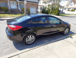 Black Kia Forte parked on the street, features low mileage and keyless entry.