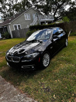 2016 BMW 5 Series in excellent condition, parked on grass with a house in the background