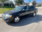 2004 Toyota Avalon XLS FWD in black, showing some exterior flaws and low mileage for sale.