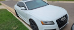 2009 Audi A5 S-Line in white parked on the street with tinted windows and sleek design.