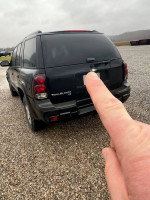 2005 Chevrolet TrailBlazer LS with 143,000 miles, shown from rear, in a gravel parking area.
