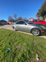 Silver INFINITI G35 coupe parked on a driveway with a clean title and strong engine performance.