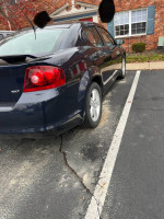 2012 Dodge Avenger SXT parked, showing rear view, ready for maintenance and tow due to alternator issue.