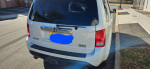 Rear view of a 2013 Honda Pilot Touring for sale, showing its stylish design and rear features.