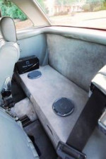 Interior view of a 1985 Mercedes 380SL, showcasing the rear seating area and sound system.