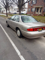 2001 Buick Century parked on the street, showing its rear view and exterior condition.