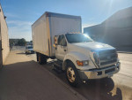 2007 Ford F-650 XLT truck with 112K miles, 5.9 Cummins engine, and 14ft box parked outside