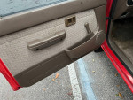 Interior view of a 1995 Toyota Tacoma Xtra cab door with original features and fabric.