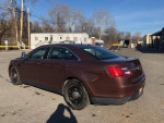 2015 Ford Taurus Police car in brown color parked in an outdoor lot, showing recent repainting and no dings.