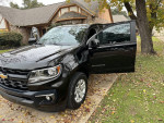 2021 Chevrolet Colorado LT 4WD in excellent condition with low mileage parked outside a house