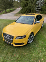 2010 Audi S4 in unique yellow color parked on grass with trees in the background