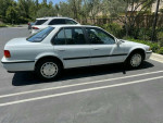 Side view of a white Honda Accord EX Sedan parked, showcasing its stylish design and manual transmission.