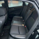 Interior view of Honda Civic Sport showing spacious back seats with black upholstery