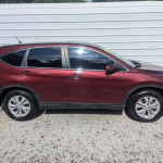 Side view of a red Honda CR-V EX with sunroof, backup camera, and 107K miles for sale.