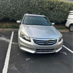 Silver Honda Accord parked, featuring leather seats and Bluetooth, clean title with 138k miles.