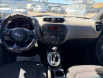 Interior view of a 2015 Kia Soul showing dashboard and steering wheel with USA traffic in background.