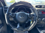 Interior view of a 2015 Kia Soul with a black steering wheel and dashboard features