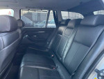 Interior view of the 2002 BMW 5 Series 525i with black leather seats and spacious rear seating.