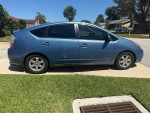 2007 Toyota Prius hatchback in good condition, parked in a residential area, showcasing the car's side profile.
