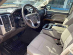 Interior view of a 2014 GMC Sierra 1500 SLE showcasing seats and dashboard features
