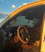 Interior view of a 2006 GMC Sierra 1500HD SLT with a stylish steering wheel cover and dashboard details.