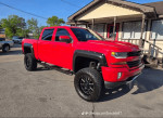 2016 Chevrolet Silverado 1500 Rocky Ridge, red, lifted with off-road wheels and aggressive stance, perfect for tough terrain.