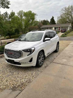 2020 GMC Terrain Denali SUV in white, showcasing a luxury design and efficient turbo engine.