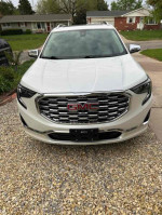 Front view of a 2020 GMC Terrain Denali SUV with a sleek design and chrome grille.