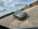 2003 Chevrolet Monte Carlo LS coupe parked on asphalt, showcasing its design and spacious interior.