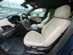 Interior view of a 2022 Chevrolet Traverse High Country with beige seating and dashboard features.