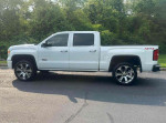 2014 GMC Sierra 1500 white regular cab truck parked on road, featuring large wheels and 4WD.
