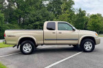 2004 Toyota Tundra 2dr Regular Cab 4WD in a parking lot, showcasing its durable design and robust tires.