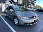 2008 Honda Civic LX coupe in gray, well-maintained, parked outside with clear sky.