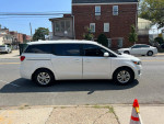 Side view of a 2016 Kia Sedona L with 105k miles, featuring a clean design and spacious interior for family travel.