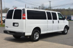 2016 Chevrolet Express 3500 Cargo Van in white, side view with sliding doors, parked on a street.