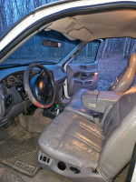 Interior view of a 1997 Ford F-150 Lariat 4WD with leather seats and dashboard controls.